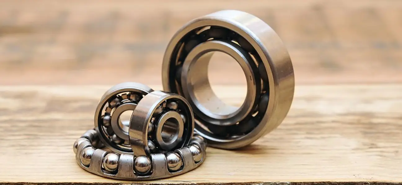 Two ball bearings are sitting on a table.