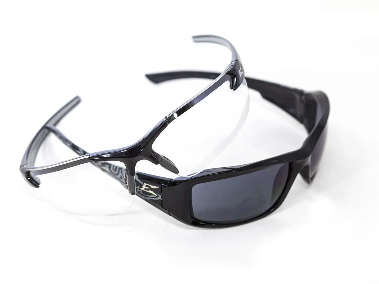 A pair of sunglasses with black frames and grey lenses.